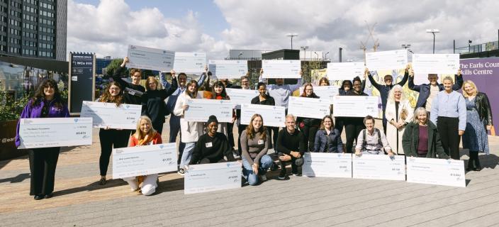 Representatives from successful charities holding large cheques